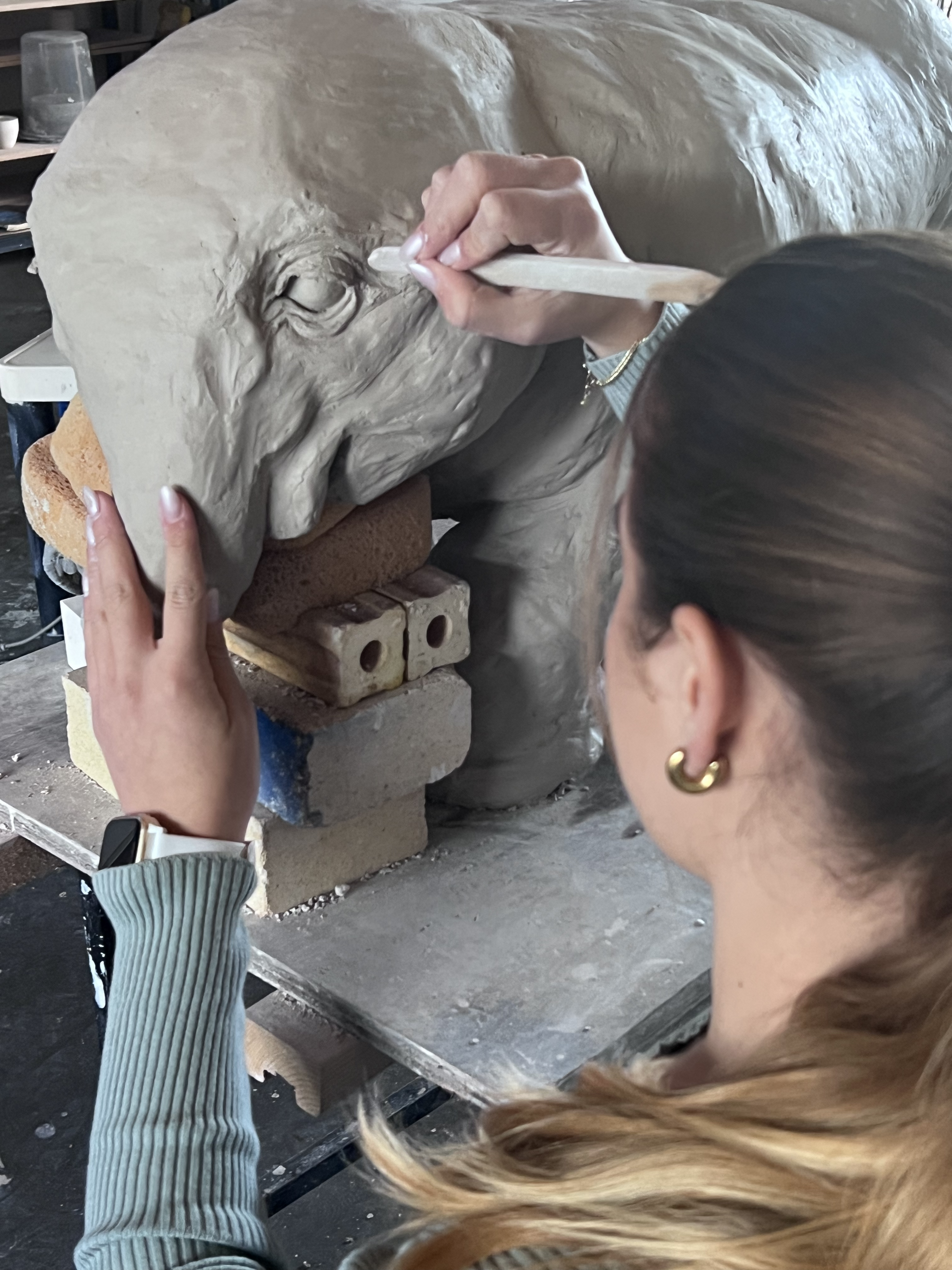 Chiana Kelly puts the final touches on a ceramic elephant at Francis Parker School