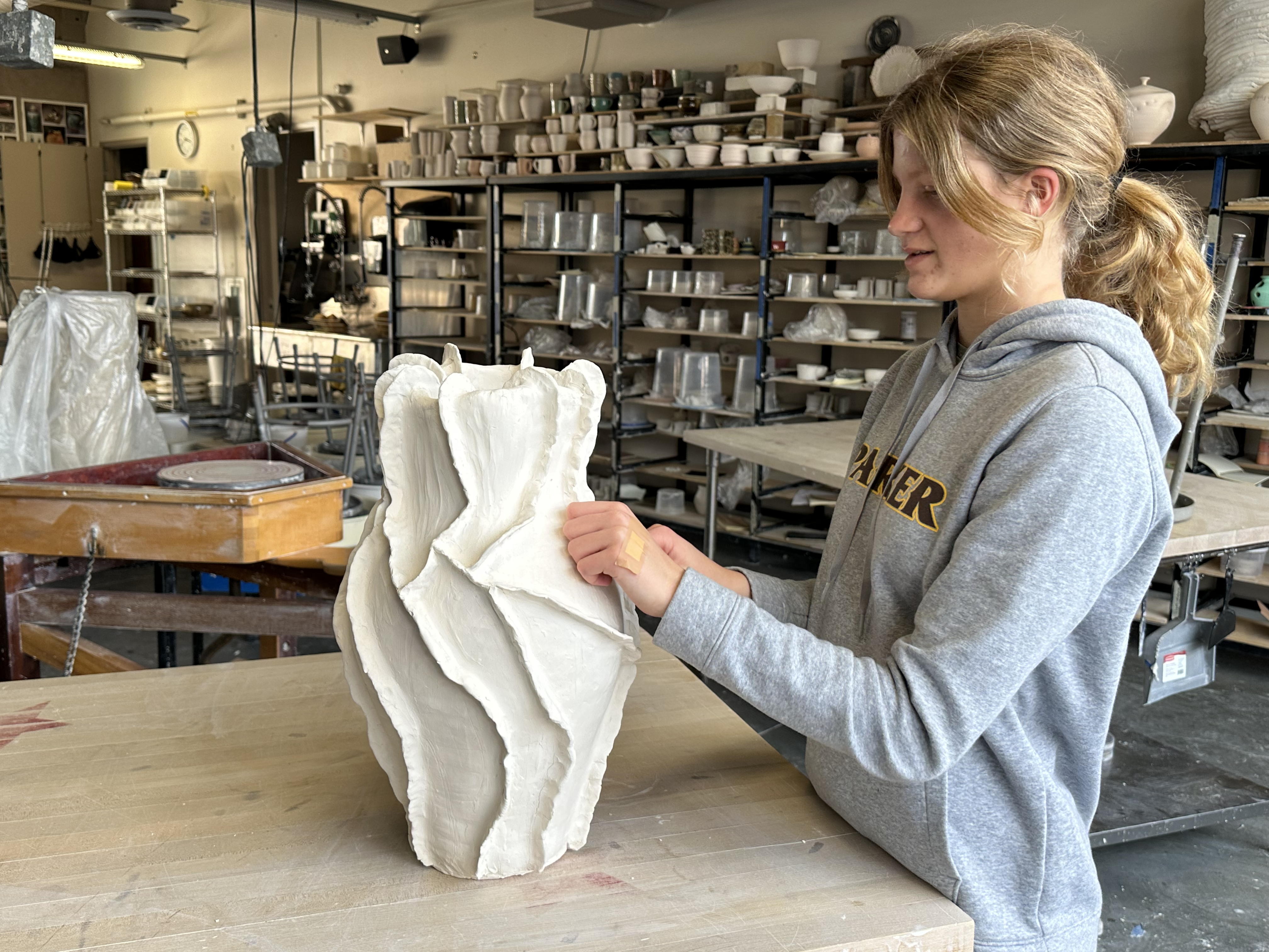 Teresa Cornuelle readies a ceramics piece for competition in the Francis Parker School ceramics studio.