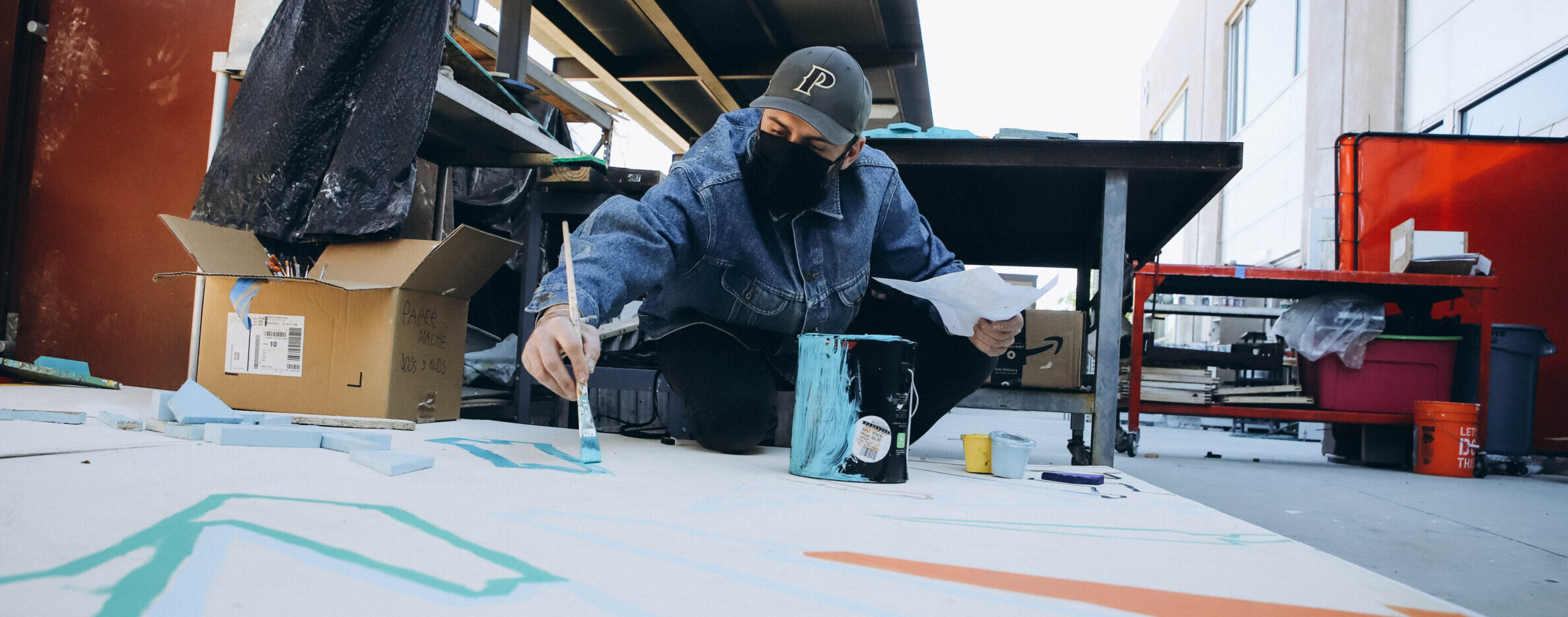 Art teacher Paul Mericle working on MLK mural